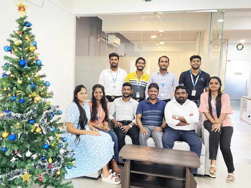 Pixzarloop team portrait beside the decorated Christmas tree